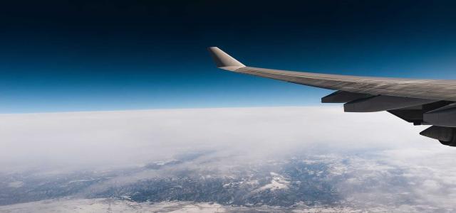 Wing of plane in sky.